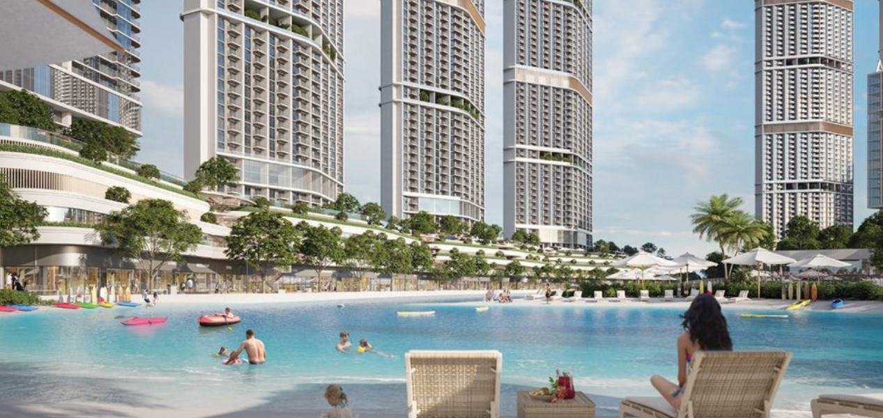 Skyscape Aura Sobha Hartland beachfront pool and recreational area with residents enjoying leisure activities.