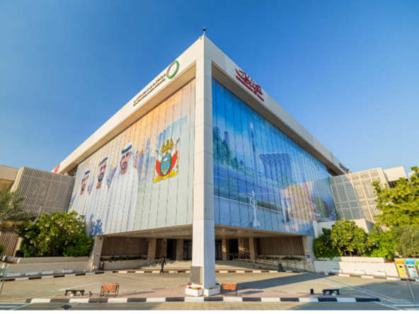 Front view of DEWA headquarters in Dubai under a clear blue sky, important for DEWA registration process